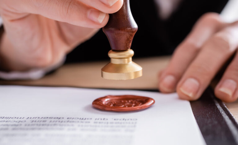 close up view of cropped notary stamping contract with wax seal,stock image