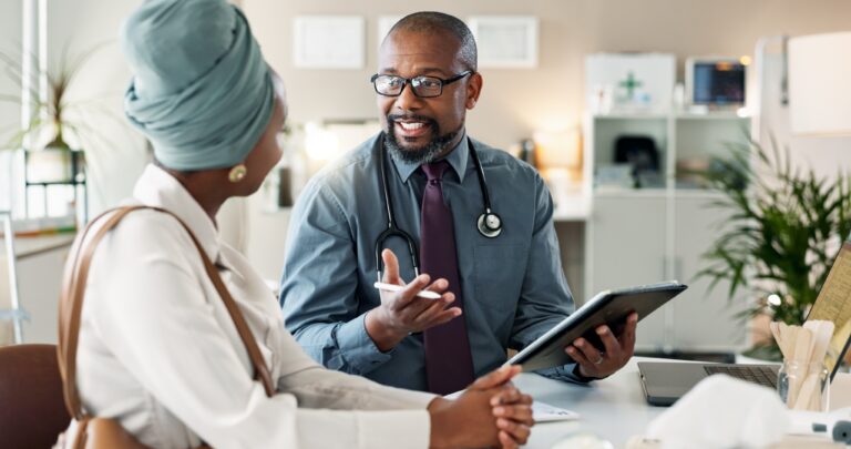 health care professional speaking with patient symbolizing a patient receiving treatment for dermatology as utilization grows