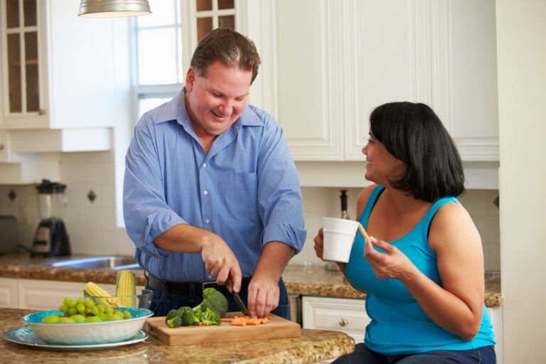Promotional image for GLP-1 Pathways and DirectAccess showing two adults in a home kitchen preparing fresh vegetables and healthy foods on a countertop.
